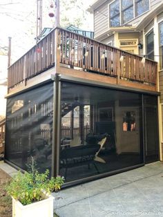 an enclosed patio area with stairs and railings