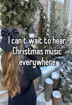 a girl with long hair wearing a bow in front of snow covered trees, and the words i can't wait to hear christmas music everywhere