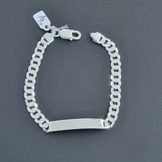 Weight: 10.26 Grams (Approximate) Lenght: 8 Inch Width: 6.8mm Metal: 925 Sterling Silver Stamped: 925 Classic Sterling Silver Charm Bracelet With Silver Chain, Classic White Gold Charm Bracelet With Silver Chain, Classic Silver Name Bracelet With Polished Finish, Classic Silver Name Bracelet, Hallmarked, Classic Silver Name Bracelet With Jubilee Detail, Classic Silver Charm Bracelet, Classic Silver Name Bracelet, Classic Silver Hallmarked Name Bracelet, Sterling Silver White Gold Jubilee Name Bracelet