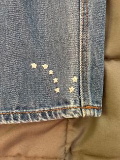 a pair of blue jeans with white stars on them