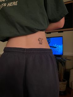 a person with a small tattoo on their stomach