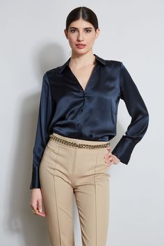 Nothing beats the chic factor and luxe patina of a Silk Satin shirt. Our button-down design features a v-neckline that is perfect for layering under a blazer or wearing on its own- you will live in this shirt all season long. Elie Tahari Exclusive Long Sleeve Silk Satin Button Down shirt 100% Silk Relaxed Fit; Runs true to size. Model is 5'9" and wearing size S Length From Shoulder to Hem: Back 26"L, Sleeve 32.5"L (approx. length for size S) Dry Clean Only Imported Style #: E107G513 Satin Button Down Shirt Outfit, Satin Shirt Outfit, Satin Button Down Shirt, Full Sleeve Top, Tahari Dress, Expensive Taste, Satin Color, Satin Shirt, Long Sleeve Short Dress