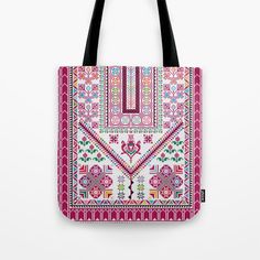 a pink tote bag with an embroidered design