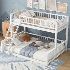 a white bunk bed with two sets of stairs on the bottom and one set below