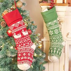 two christmas stockings hanging from the side of a fireplace next to a decorated christmas tree