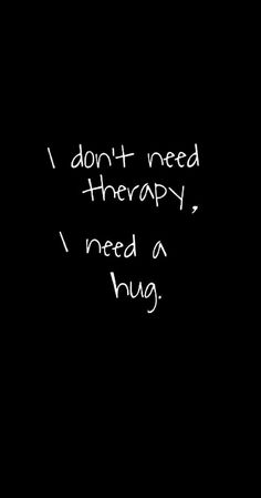 the words i don't need therapy, i need a hug written in white chalk on a black background