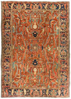 an orange, blue and red rug with many different designs on the bottom half of it