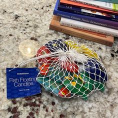 a bag filled with gummy bears sitting on top of a table next to books