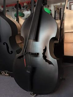 two black cellos sitting on top of each other