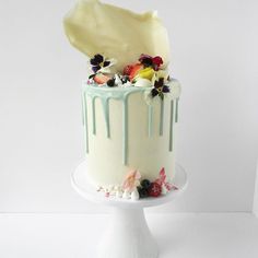 a cake with white frosting and flowers on top