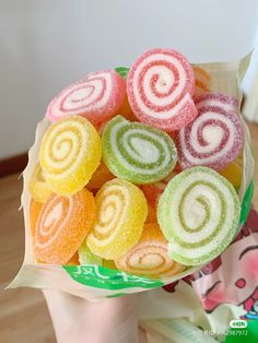 a person holding a bag full of colorful lollipops