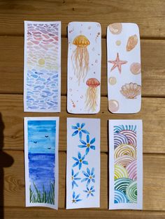 four watercolor cards with different designs on them