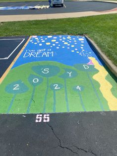 a painted parking lot with the words dream written on it