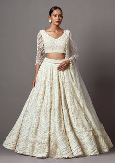 Embroidered lehenga with pearls and silver embellishments paired with a beaded blouse and dupatta. Heavy Necklace, White Lehenga, Half Saree Lehenga, Lehenga Blouse Designs, Saree Lehenga, Embroidered Lehenga, Beaded Blouse, Sleeves Ideas, Lehenga Blouse