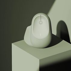 a computer mouse sitting on top of a white pedestal