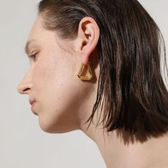 A confident style never goes unnoticed–allow your personality to shine through with these folded triangle hoop earrings, an ode to those who love retro-geometric shapes and artistic creativity. A subversive-basic design blended with wearability gives these hoops endless possibilities.

Size: 24x24mm
Material: 18k Gold Plated On Brass Trendy Gold Triangle Earrings, Modern Single Triangle Earring, Elegant Everyday Triangle Earrings, Trendy Triangle Earrings, Modern Triangle Gold Hoop Earrings, Everyday Gold Triangle Earrings, Modern Geometric Single Hoop Earring, Geometric Gold Hoop Earrings For Everyday, Gold Geometric Hoop Earrings For Everyday