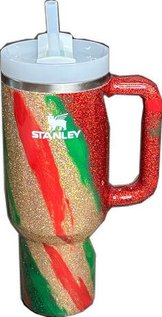 a red, white and green coffee cup with a straw in the bottom that says starley