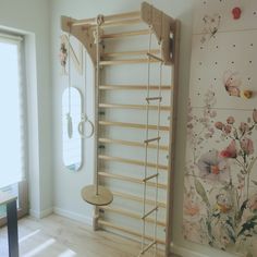 a room that has some kind of wooden rack in the corner and flowers on the wall