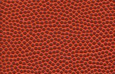 the texture of an orange surface with black dots is shown in close up, and it looks like something out of space