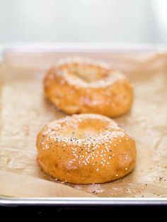 three bagels sitting on top of a piece of wax paper