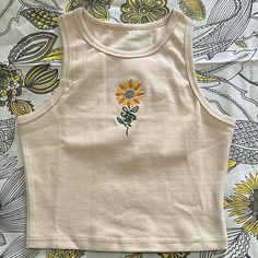 Crop top with sunflower embroidery.  Made of Cotton and Spandex. Tank Top Embroidery Ideas, Embroidered Fitted Tank Top For Spring, Fitted Embroidered Tank Top For Spring, Summer Casual Tank Top With Floral Embroidery, Fitted Cotton Tank Top With Floral Embroidery, Embroidered Fitted Casual Crop Top, Casual Embroidered Fitted Tank Top, Casual Embroidered Fitted Crop Top, Fitted Floral Embroidery Tank Top For Spring