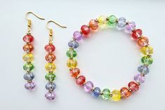 All the colors of the rainbow are represented in this beautiful fairytale-inspired jewelry set! Transparent glass pumpkin beads in bright red, tangerine orange, lemon yellow, apple green, periwinkle blue, and lavender purple are each highlighted with sparkling gold-tone crystal rondelles. Golden flecks decorate the green, yellow and blue pumpkins, adding a magical touch to this festive look! The dangle earrings are approximately 2 inches long, and the stretch bracelet is between 7.5 and 8 inches long for a generous fit. To keep your rainbow pumpkin jewelry from tarnishing, avoid running away from the palace in the rain, and any other damp activities. Rainbow Beaded Round Jewelry, Multicolor Czech Glass Jewelry For Party, Multicolor Czech Glass Party Jewelry, Nickel-free Rainbow Jewelry For Party, Cadmium-free Multicolor Jewelry Gift, Nickel-free Rainbow Round Bead Jewelry, Nickel-free Rainbow Round Beaded Jewelry, Rainbow Beaded Glass Jewelry, Adjustable Rainbow Jewelry With Faceted Beads