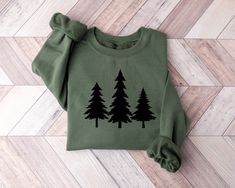 Christmas Tree Sweatshirt, Christmas Shirts, Winter Sweatshirt, Women's Christmas Sweatshirt, Holiday Sweaters for Women, Christmas Crewneck * High quality and super soft, comfortable shirt. Made with top-of-the-line vinyl and pressed with a professional grade heat press. * Please check all color and size charts before place the order. Since all shirts are custom made based on your selection, I don't accept return or exchange unless there is an issue with your order. *We're working with different shirt brands based on the color/size availability. All shirts we use are soft style, not heavy cotton. Solid colors are all cotton and heather colors are cotton/poly blend. (there may be exceptions) *Our Sweatshirt 70% SoftLume combed and ring-spun cotton, 30% polyester fleece- with 100% SoftLume Winter Wonderland Trees, Scout Mom, Scout Leader, Womens Christmas Shirts, Christmas Tree Shirt, Winter Shirts, Tree Shirt, Winter Sweatshirt, Christmas Gifts For Friends