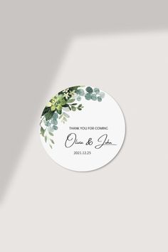 a wedding sticker with greenery on it