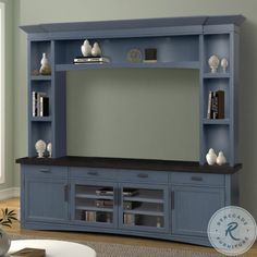 a blue entertainment center with bookshelves and shelves