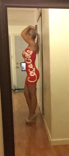 a woman in a coca cola dress taking a selfie