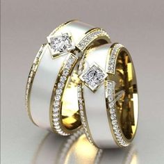 two gold and white wedding rings with diamonds