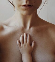 a woman with her hands on her chest