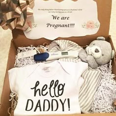 a baby gift box with a teddy bear, t - shirt and other items in it