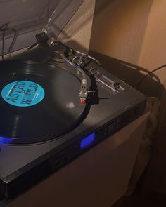 an old record player with blue lights on it