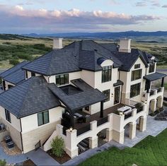 an aerial view of a large home in the mountains