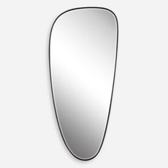 an oval shaped mirror on the wall with a black border around it and a white background