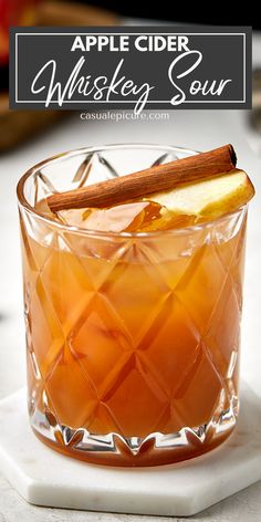 an apple cider whiskey sour recipe in a glass with cinnamon stick on the rim