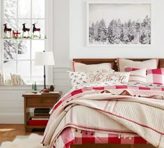 a bed with red and white plaid comforter in a bedroom