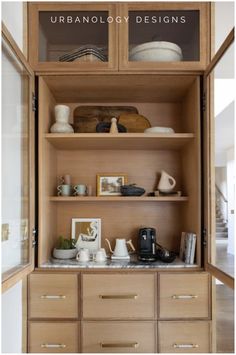 an open bookcase filled with lots of books and vases on top of wooden shelves