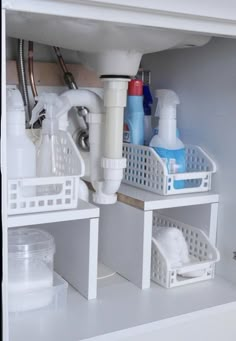 the under sink storage area is clean and organized