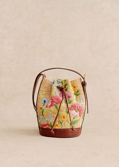 Mini bucket bag;Made in our Madagascan atelier;Hand woven and embroidered exterior;Number of hours of braiding (38H);Raffia and textile exterior;Unlined;Leather handle;Metal parts in brass with light gold finish;Shackle length: 51 cm / 20.1 in;Adjustable handle;Carried on the shoulder and crossed over;Closes with leather ties;Weight of the bag : 0.3 kg / 10.6 oz;Dimensions: 22 x 14.5 x 15 cm / 8.7 x 5.7 x 5.9 in Green Bouquet, Mini Bucket Bag, Mini Bucket, Mini Bucket Bags, Basket Bag, Harper's Bazaar, Embroidery Flowers, Free Bag, Parisian Style