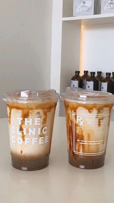 two coffee cups sitting on top of a counter