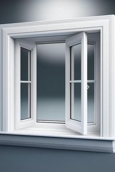 an open window on the side of a wall with white trim and windowsills