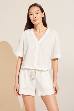 In 1996, Eberjey co-founders Ali and Mariela understood the visceral desire for beautiful, functional sleepwear that supported sleep and individual style. At last, pajamas can be sensual, comfortable, tailored, and effortless. The breathable Crinkle Woven Short Sleeve Top/Short Set in Ivory/Canyon Sunset features special, contrast embroidery stitch detail and feminine, curved cuffs. It features a button-down V-neck top, high-rise shorts with a drawstring waist, covered buttons, and contrast embr Contrast Embroidery, Embroidery Stitch, Short Pj Set, Cotton Midi Dress, Silk Shorts, Cotton Pyjamas, High Rise Shorts, Long Shorts, Short Pajama Set