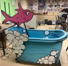 a pink fish in a blue tub with bubbles