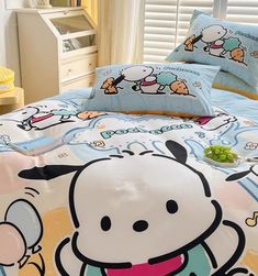 a bed with hello kitty sheets and pillows