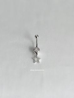 a silver star belly ring on a white background