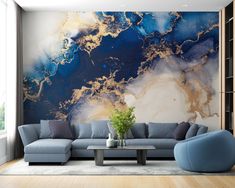 a living room with blue couches and a large painting on the wall