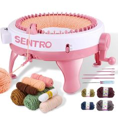 the knitting machine is pink and has many different colors of yarn in front of it