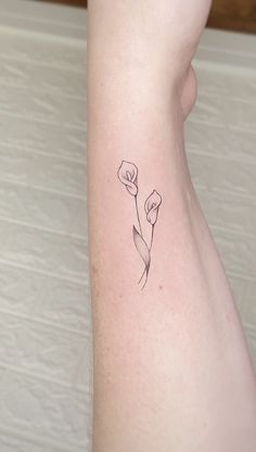 a small flower tattoo on the ankle